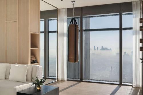 a living room with a couch and a large window at SIRO One Za'abeel in Dubai