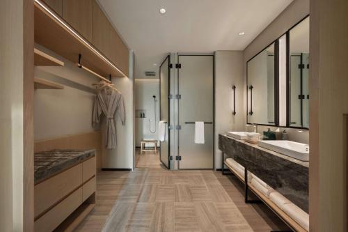a bathroom with a sink and a tub and a mirror at SIRO One Za'abeel in Dubai