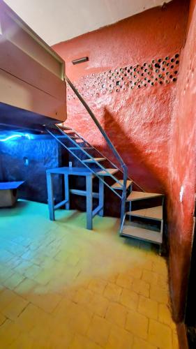 a staircase in a room with a red wall at Casa Rosa in Sayulita