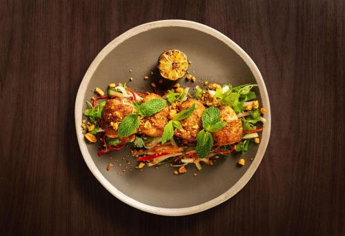 a plate of food on a wooden table at SIRO One Za'abeel in Dubai