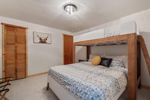 a bedroom with a bed with a wooden bed frame at Shanty Creek, Golf, Families, Vacation, Pool Pass in Bellaire