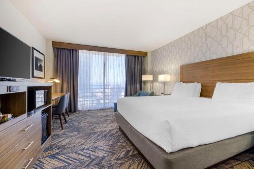 a hotel room with a large bed and a television at Best Western Plus Bayside Inn in San Diego