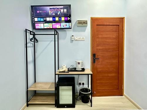 a room with a table with a tv on the wall at Century Sapphire - Near KSL & Holiday Plaza in Johor Bahru