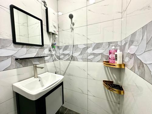 a white bathroom with a sink and a mirror at Century Sapphire - Near KSL & Holiday Plaza in Johor Bahru