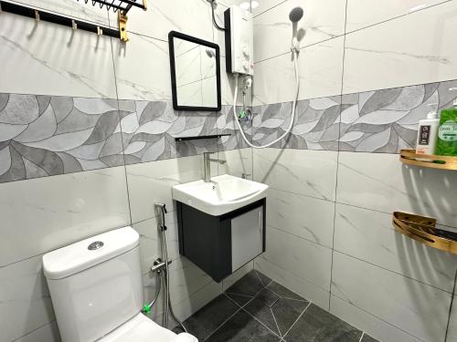 a bathroom with a white toilet and a sink at Century Sapphire - Near KSL & Holiday Plaza in Johor Bahru