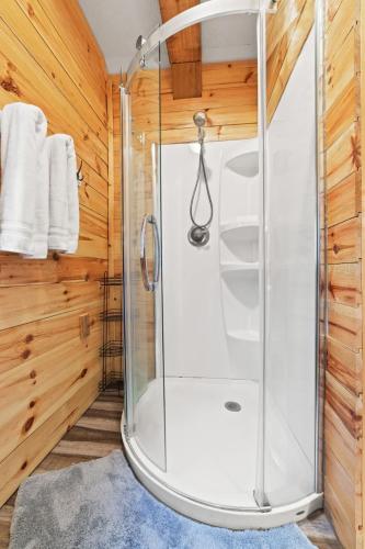 a shower with a glass door in a bathroom at Camp Evan- Shanty Creek, Schuss Mtn in Bellaire
