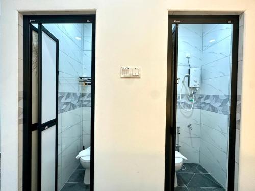 two glass doors in a bathroom with a toilet at Century Sapphire - Near KSL & Holiday Plaza in Johor Bahru