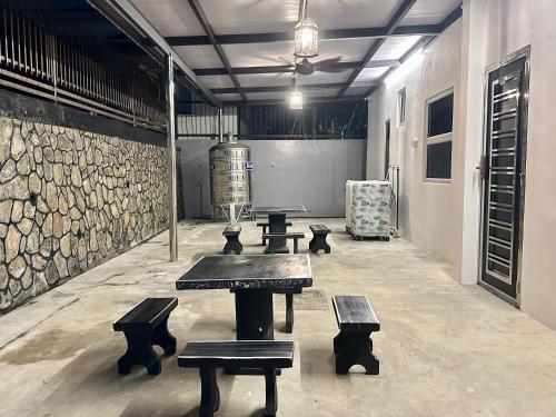 a room with benches and a table and a lamp at Century Sapphire - Near KSL & Holiday Plaza in Johor Bahru