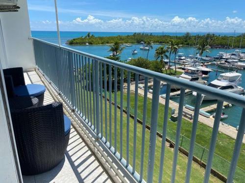 a balcony with a view of a marina and boats at Isleta Marina- Paraíso Costero in Fajardo