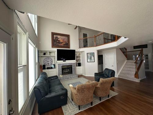 a living room with a couch and a fireplace at Tiller House - Savannah Room in Windsor