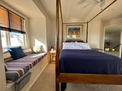 a bedroom with a large bed and a window at Tiller House - Savannah Room in Windsor