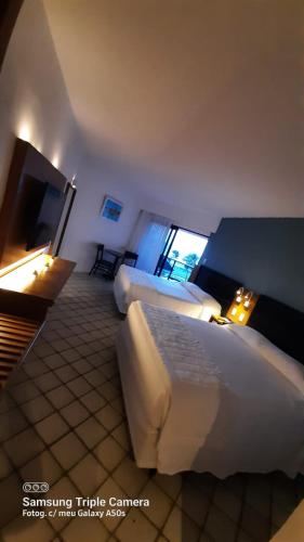 Ένα ή περισσότερα κρεβάτια σε δωμάτιο στο Hotel Pirâmide Natal
