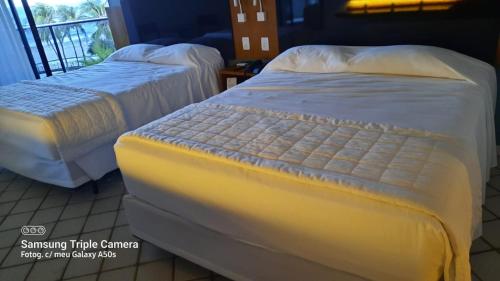Ένα ή περισσότερα κρεβάτια σε δωμάτιο στο Hotel Pirâmide Natal