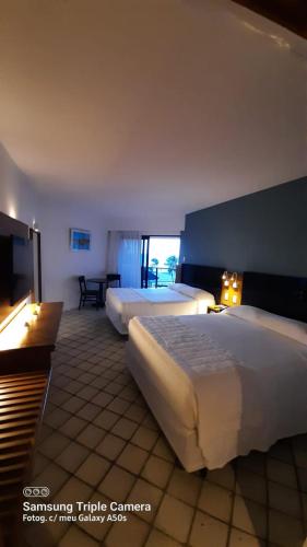 Ένα ή περισσότερα κρεβάτια σε δωμάτιο στο Hotel Pirâmide Natal
