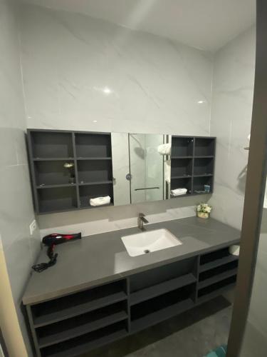 a bathroom with a sink and a mirror at Hotel Plaza Corotú-HPC in Santiago