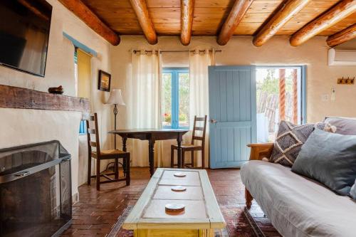 a living room with a couch and a table at Casita Azul, Historic and Cozy Santa Fe Adobe in Santa Fe