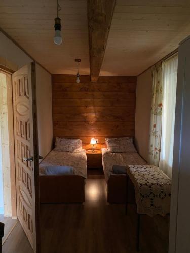 a bedroom with two beds and a door open at Dom Na Wsi ,, Koszelówka " in Koszele