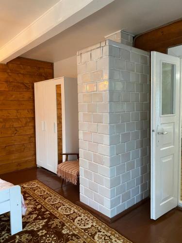a room with a brick wall next to a door at Dom Na Wsi ,, Koszelówka " in Koszele