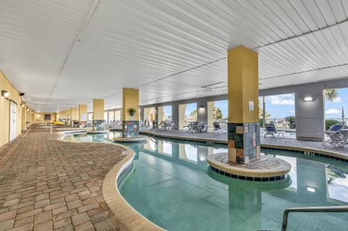 a large pool in a building with a large ceiling at Camelot by the Sea in Myrtle Beach