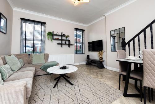 a living room with a couch and a table at Park House, Refurbed Modern Interior, Located In Finsbury Park in London