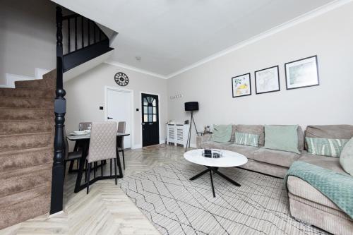 a living room with a couch and a table at Park House, Refurbed Modern Interior, Located In Finsbury Park in London