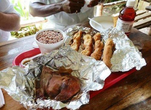 a tray with a turkey and other food on a table at Oceanview 1-Bed Apt w Pool Bar & Beach Access in Montego Bay