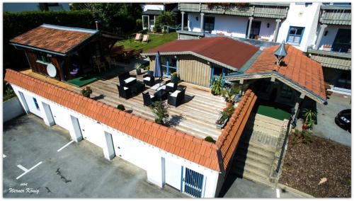 an overhead view of a house with a wooden deck at Pension Landhaus Koller - Adults only in Bodenmais