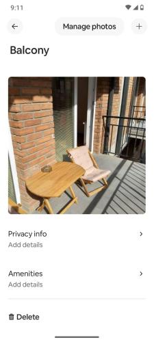 a wooden table and two chairs on a patio at Katos home in Tbilisi City