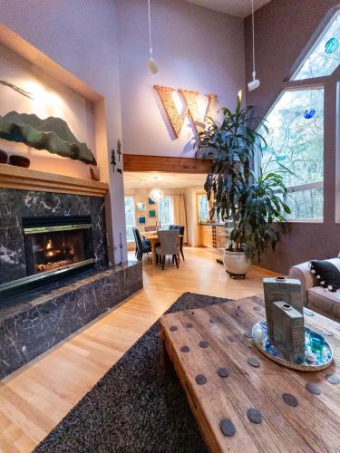 a living room with a fireplace and a table at The Mountain House in Corvallis