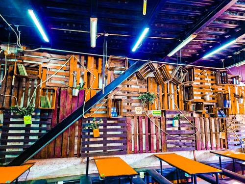 a room with wooden walls and tables and a staircase at Guest House del Valle in Mexico City