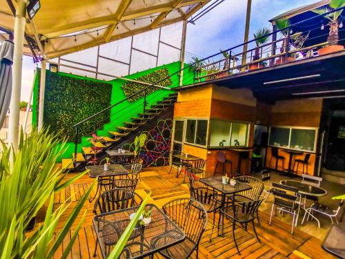 a patio with tables and chairs and a staircase at Guest House del Valle in Mexico City