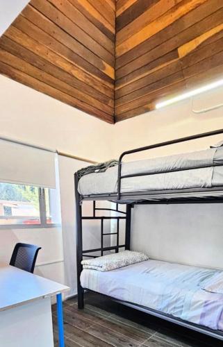 a room with two bunk beds and a desk at Guest House del Valle in Mexico City