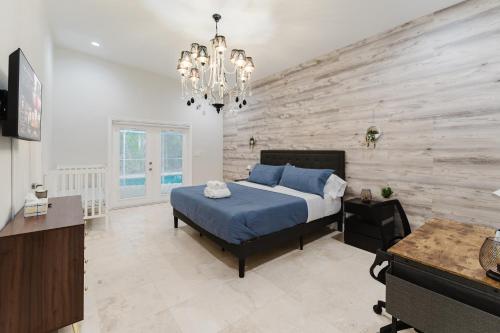 a bedroom with a blue bed and a wooden wall at Beautiful Aventura Villa Sleeps 26 in Miami