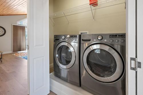 a laundry room with two washing machines in a house at Upper Deck by Simple Life Rentals in Sturgeon Bay