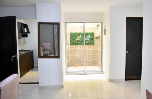 a living room with a sliding glass door at Hotel Iguaraya Inn in Ríohacha