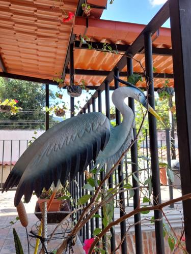 a statue of a bird standing on a fence at Hotel Nolasco in Antigua Guatemala