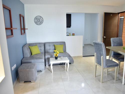 a living room with a couch and a table at Hotel Iguaraya Inn in Ríohacha