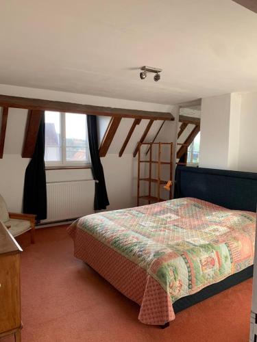 une chambre avec un lit dans une pièce avec des plafonds en bois dans l'établissement Maison de charme à Wissant, à Wissant