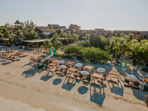 an aerial view of a beach with tables and chairs at Aldea Kuká, Luxury Eco Boutique Hotel in Holbox Island