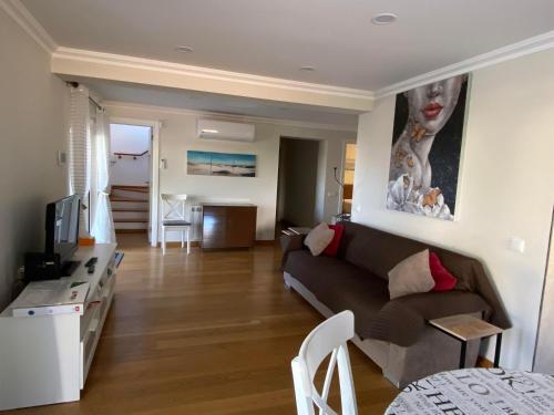a living room with a couch and a table at Alvor mountain view villa with private pool in Alvor