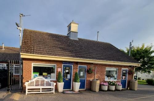 a building with a white bench in front of it at Walshs holiday park 6 berth 2 bedrooms lead person must be over 30 in Winthorpe