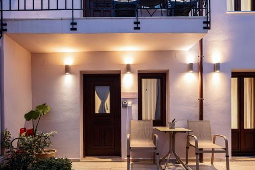 a patio with a table and chairs in front of a building at Philikon Luxury Suites in Rethymno Town
