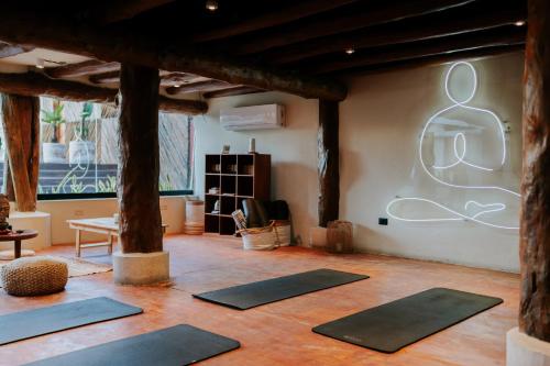a room with a bunch of yoga mats on the wall at Aldea Kuká, Luxury Eco Boutique Hotel in Holbox Island