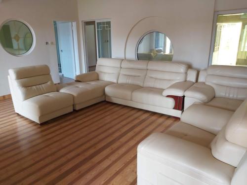 a living room with white leather furniture and mirrors at Stunning 5-Bed Family Villa in Lubumbashi Congo in Lubumbashi