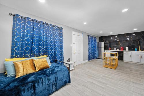 a living room with a bed and a kitchen at Comfy 2BR in Prime Spot with Free Parking and Pool in Houston