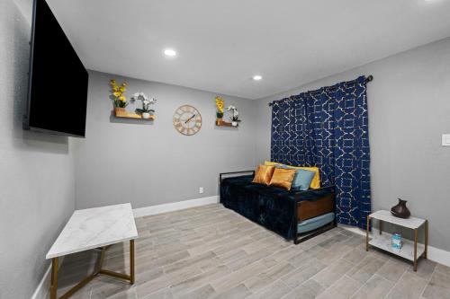 a living room with a couch and a tv at Comfy 2BR in Prime Spot with Free Parking and Pool in Houston