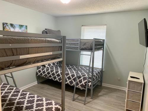 a room with two bunk beds and a tv at 208 Gunter in Saint Marys