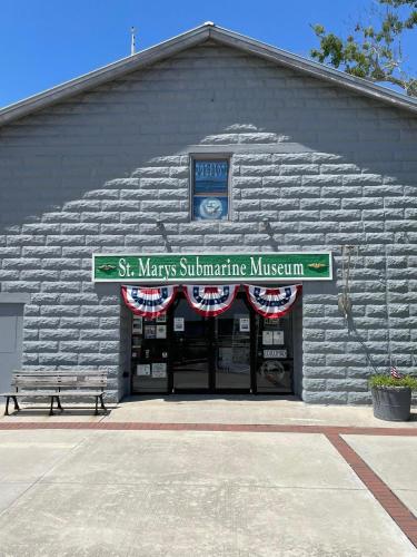 a stone building with a sign in front of it at 100 Commander in Saint Marys