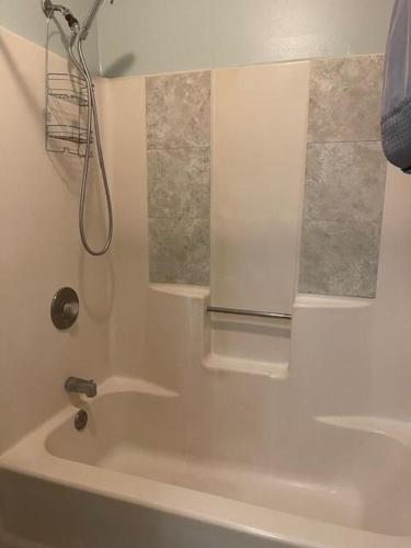 a bathroom with a shower and a bath tub at 100 Commander in Saint Marys