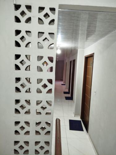 a hallway with a wall of wine bottles at HOTEL NOVAES in Castanhal